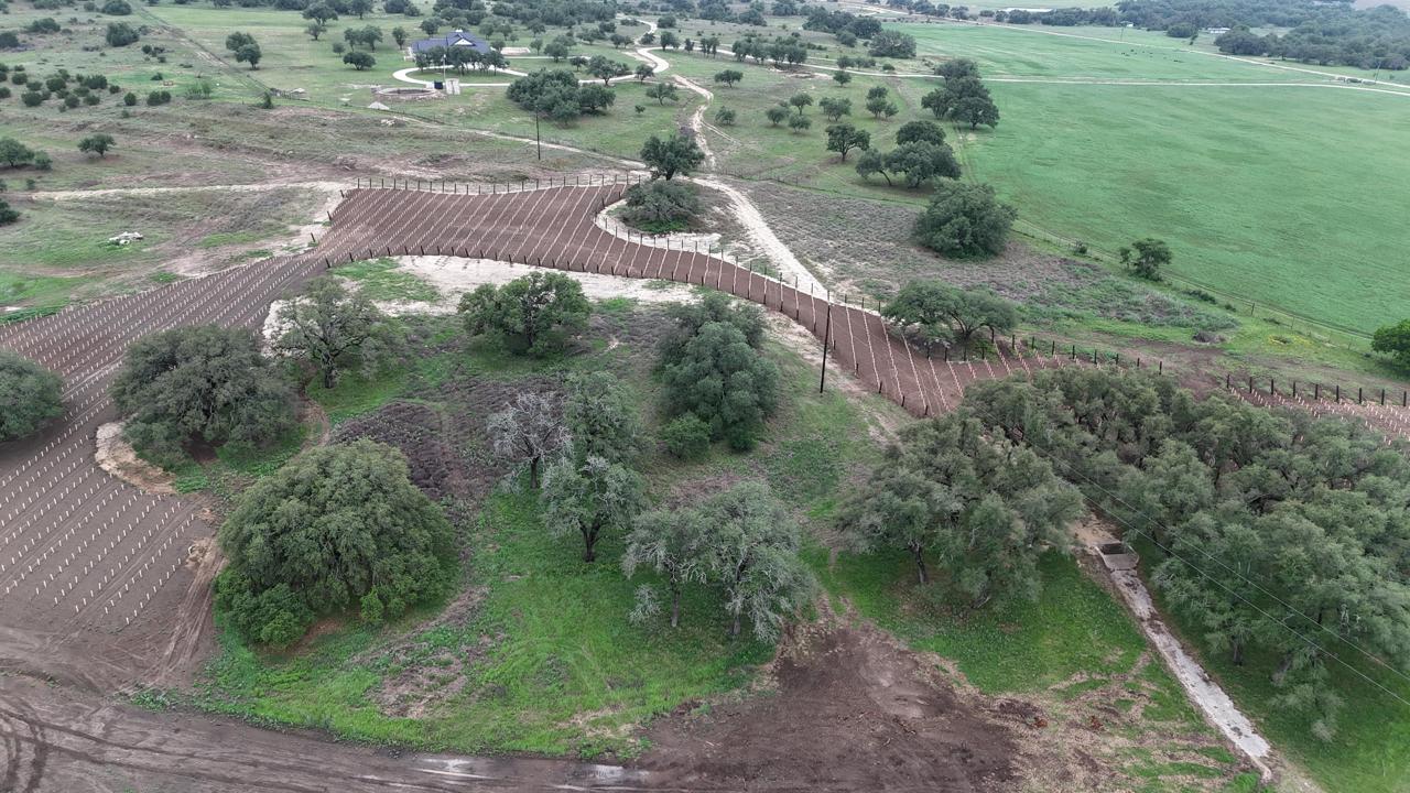 576 Young Ranch Road, Unit 8 Johnson City, TX 78636 - Photo 12 of 12 Extensive acreage featuring cultivated rows, established trees, and varied terrain