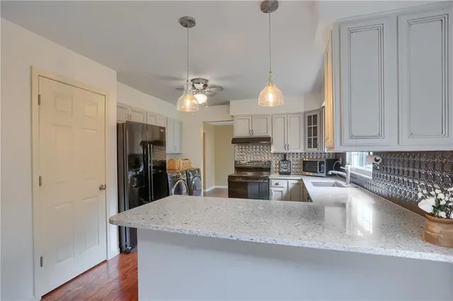 a kitchen with refrigerator a washer and dryer