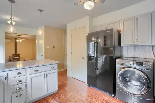 a kitchen with white cabinets and a sink