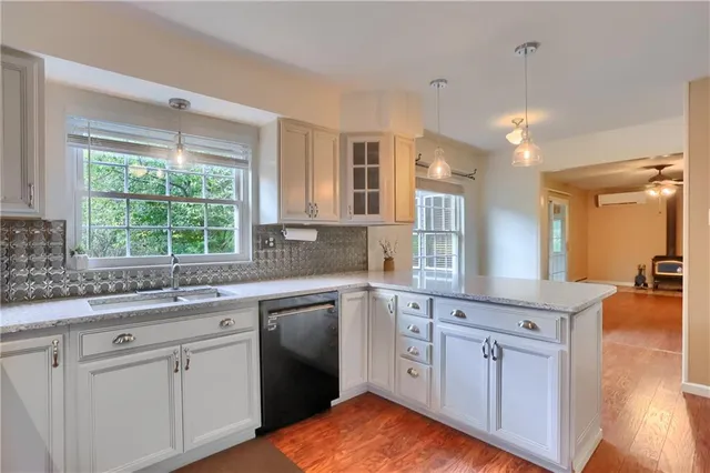a kitchen with kitchen island a large counter top space a sink stainless steel appliances and cabinets