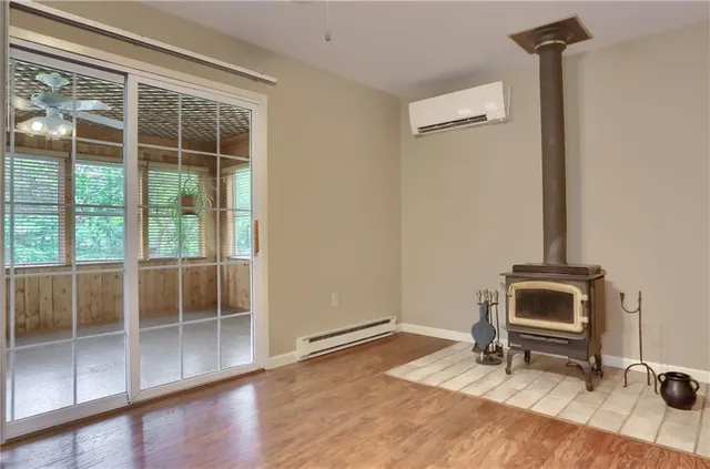 a living room with furniture and a floor to ceiling window