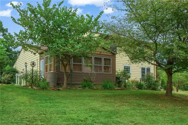 an aerial view of a house with a yard and lake view