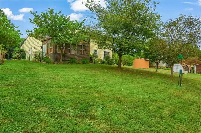 a view of a grassy field with trees