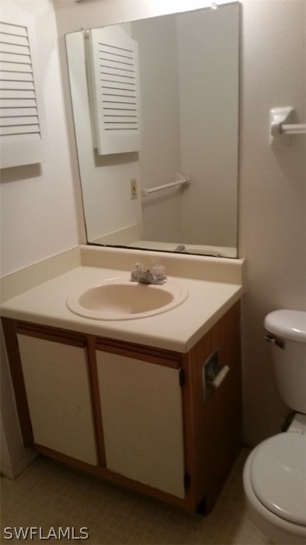 5317 Summerlin Road, Unit 1716 Fort Myers, FL 33919 - Photo 4 of 5 a bathroom with a sink a toilet and a mirror