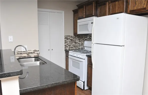 a kitchen with a refrigerator and a sink