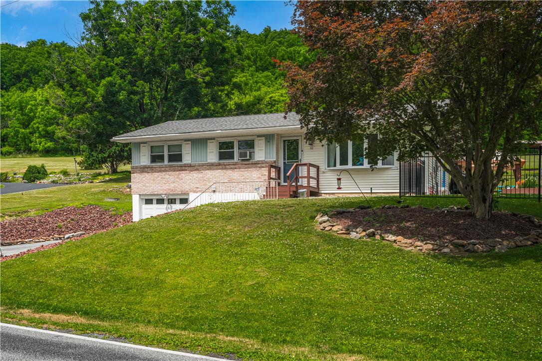 50 Kohls Road Northampton, PA 18067 - Photo 3 of 54 A classic ranch home nestled into a verdant hillside, offering privacy and scenic views.
