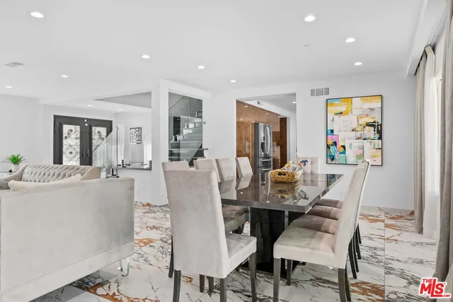 a kitchen with kitchen island a sink appliances and cabinets
