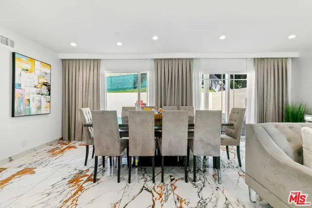 a kitchen with counter top space dining table and chairs