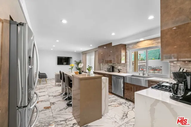 a living room with furniture a flat screen tv and a window