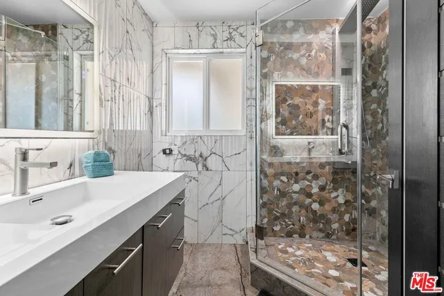 a spacious bedroom with a bed and a lamp