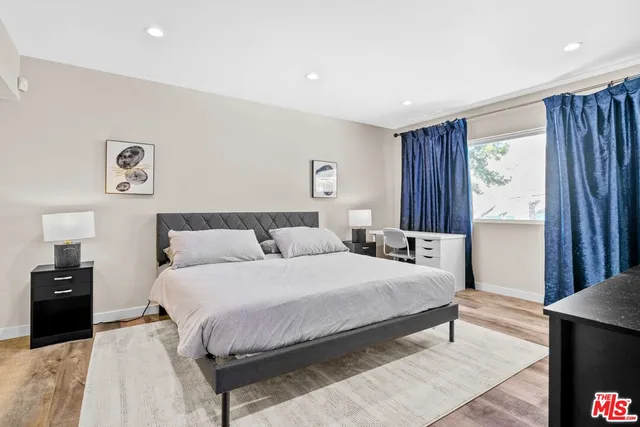 a living room with furniture and a dresser