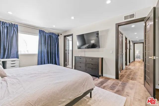 a bedroom with a bed and a dresser