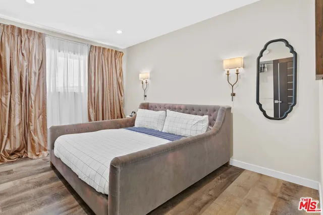 a view of a patio with table and chairs potted plants with wooden floor