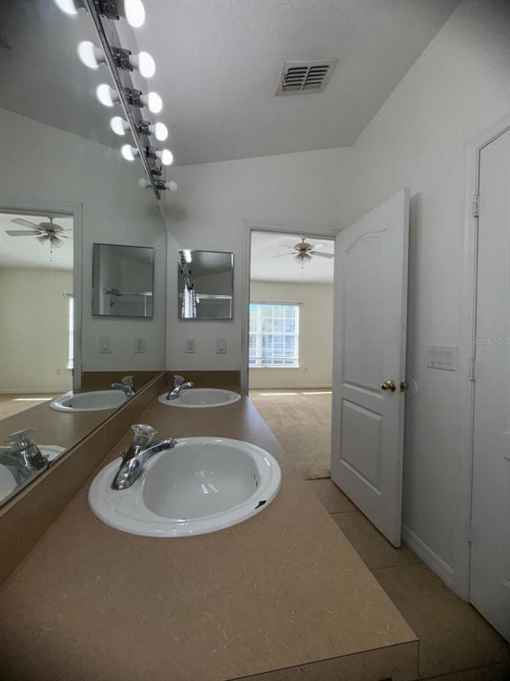 6404 South Goldenrod Road, Unit 2A Orlando, FL 32822 - Photo 15 of 21 a bathroom with a sink a light fixture and a mirror