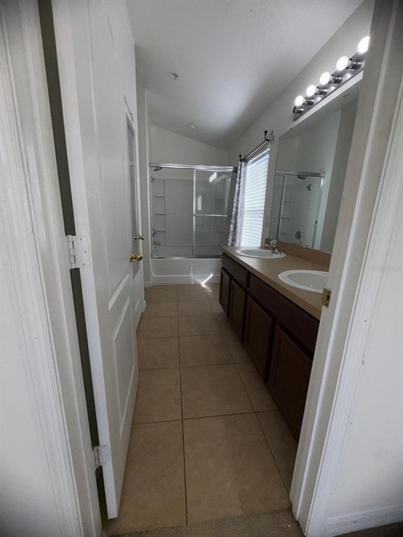 6404 South Goldenrod Road, Unit 2A Orlando, FL 32822 - Photo 18 of 21 a kitchen with a sink a refrigerator a window and cabinets