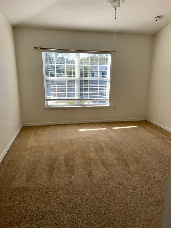 6404 South Goldenrod Road, Unit 2A Orlando, FL 32822 - Photo 19 of 21 an empty room with a window