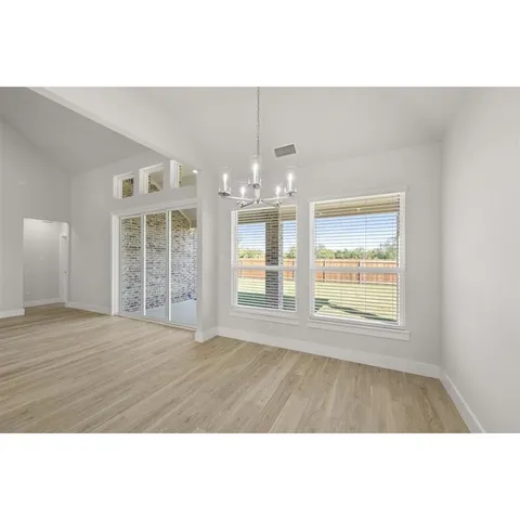 a living room with furniture and large windows