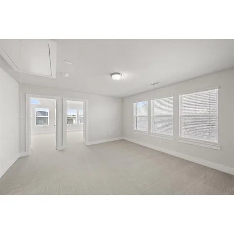 a open hall with kitchen island and wooden floor