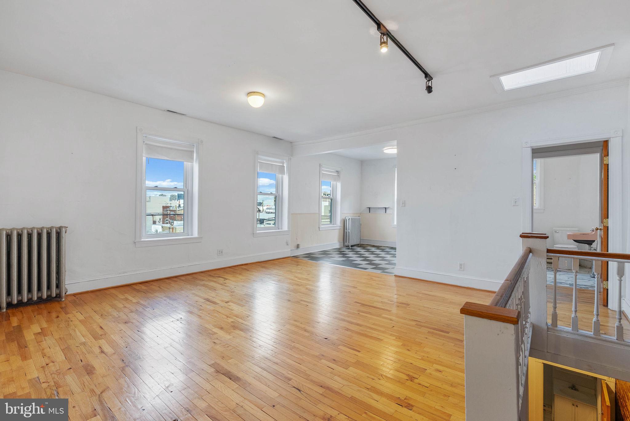 732 Tasker Street, Unit 3 Philadelphia, PA 19148 - Photo 1 of 9 a view of an empty room with window and wooden floor