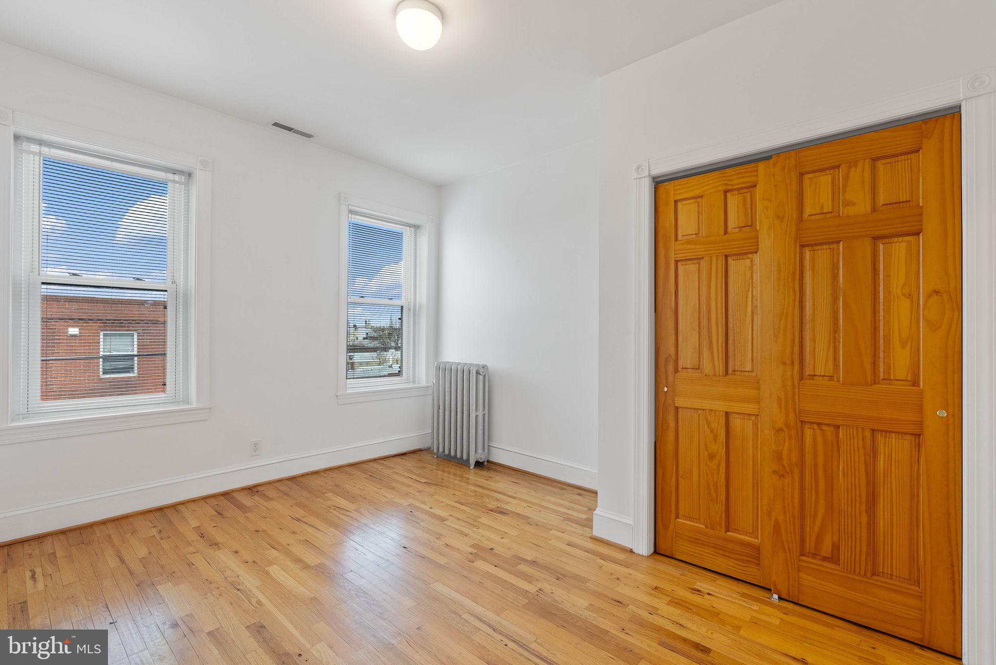 732 Tasker Street, Unit 3 Philadelphia, PA 19148 - Photo 7 of 9 a view of empty room with wooden floor and fan