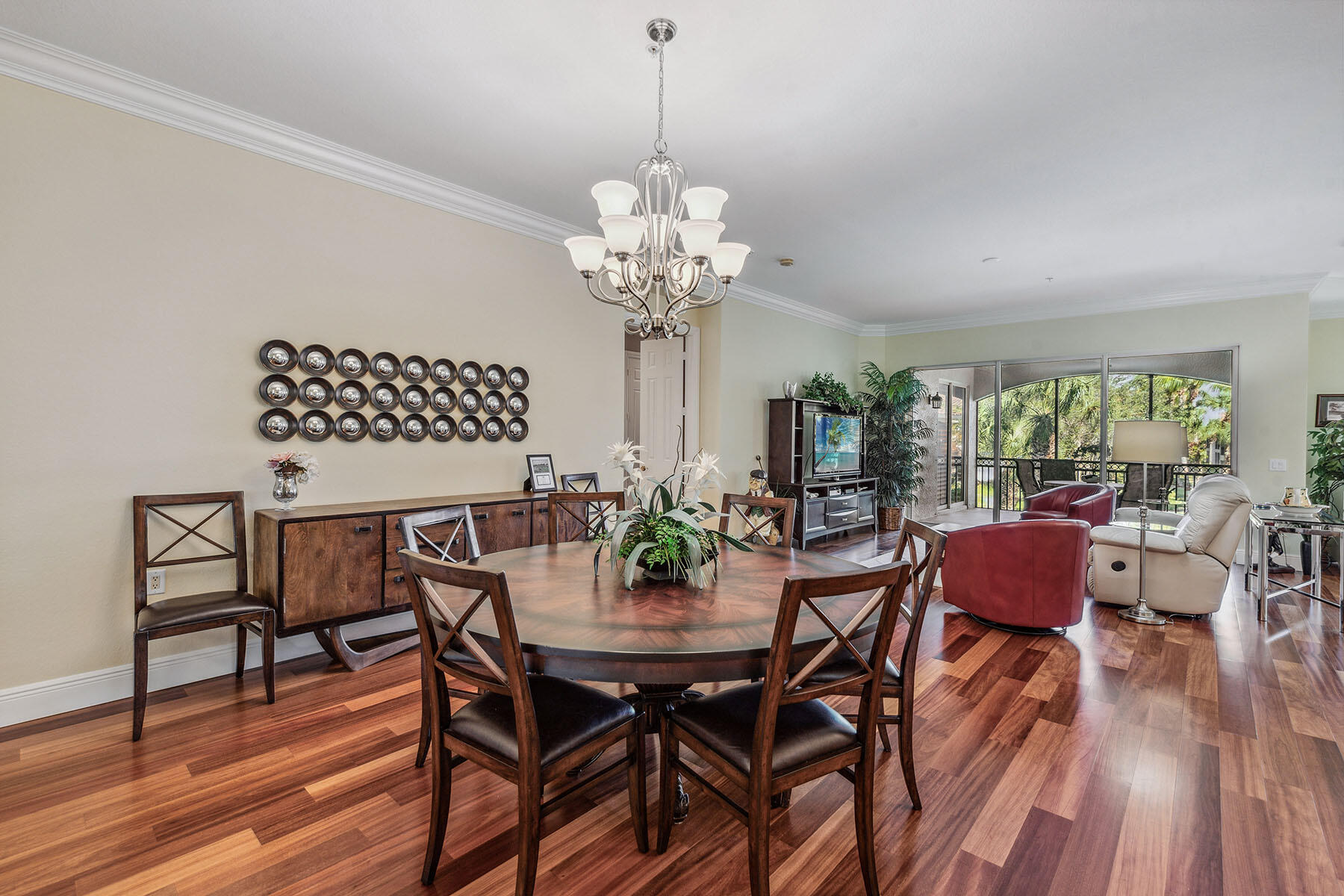 3189 Aviamar Circle, Unit 202 Naples, FL 34114 - Photo 6 of 50 a view of a dining room with furniture wooden floor and chandelier