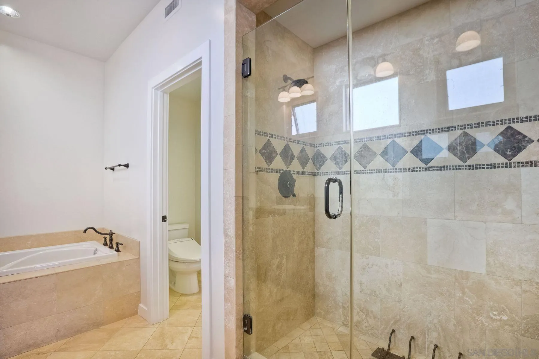 2009 MacKinnon Avenue Encinitas, CA 92007 - Photo 16 of 46 a bathroom with a bathtub and shower