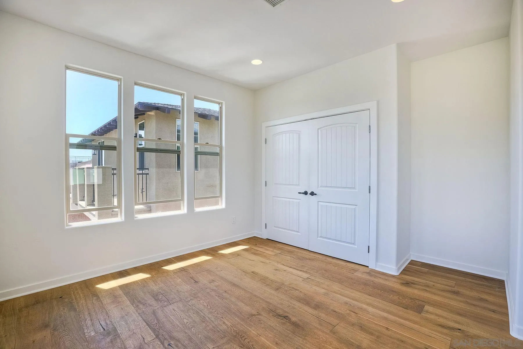2009 MacKinnon Avenue Encinitas, CA 92007 - Photo 25 of 46 a view of an empty room with wooden floor and a window
