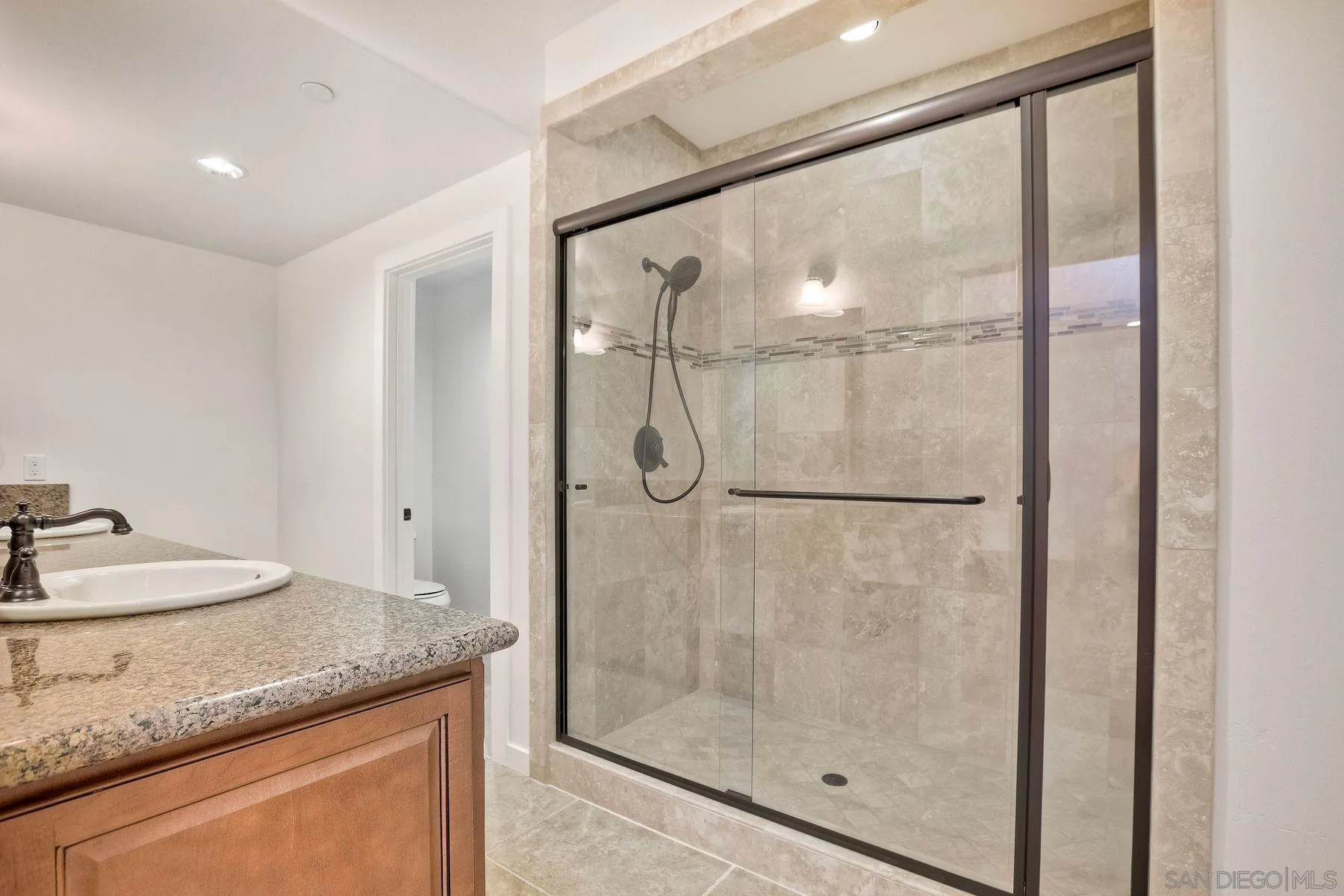 2009 MacKinnon Avenue Encinitas, CA 92007 - Photo 32 of 46 a bathroom with a granite countertop shower a sink and vanity