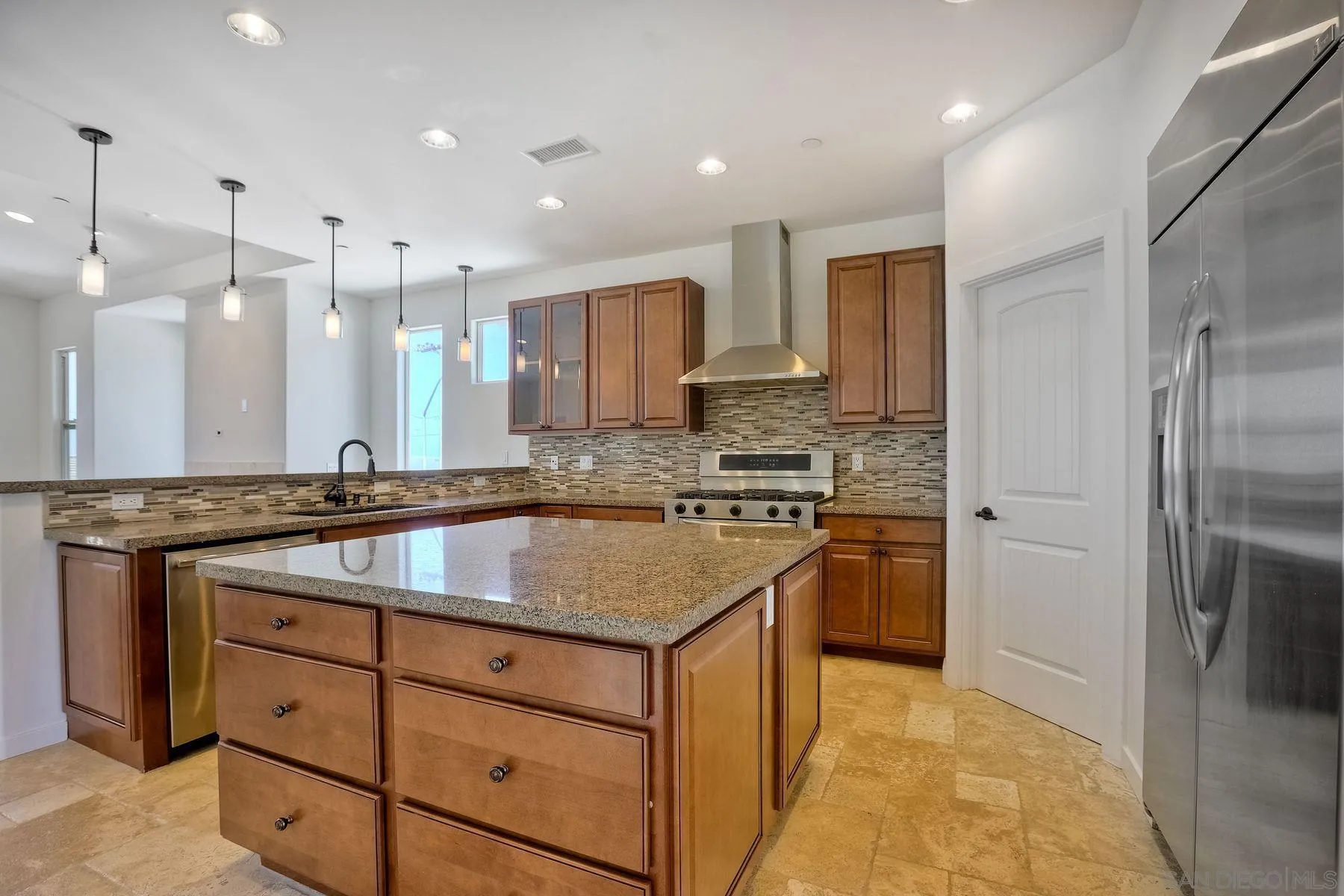 2009 MacKinnon Avenue Encinitas, CA 92007 - Photo 4 of 46 a kitchen with kitchen island granite countertop a sink appliances and cabinets