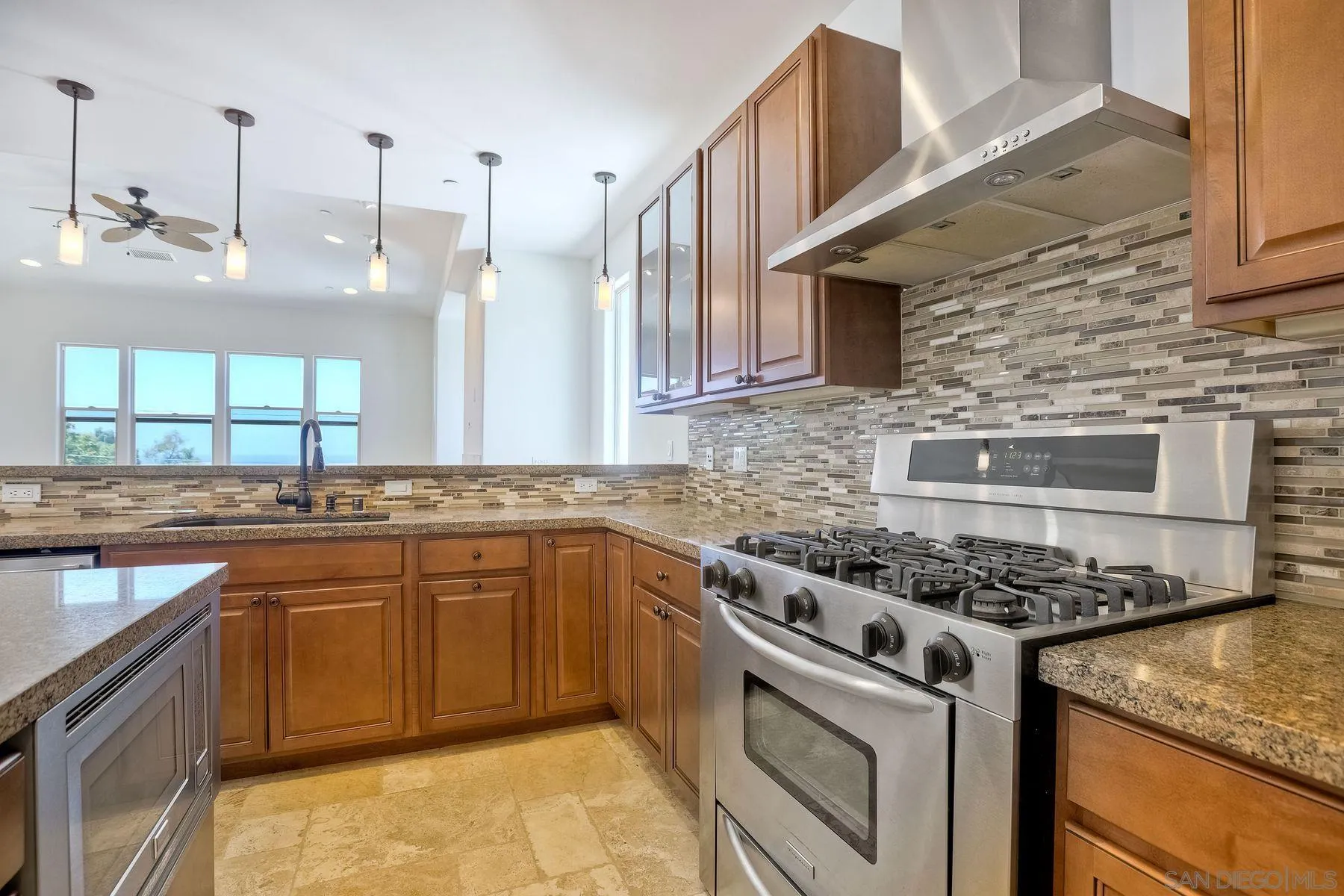 2009 MacKinnon Avenue Encinitas, CA 92007 - Photo 7 of 46 a kitchen with stainless steel appliances granite countertop a stove a sink dishwasher and cabinets