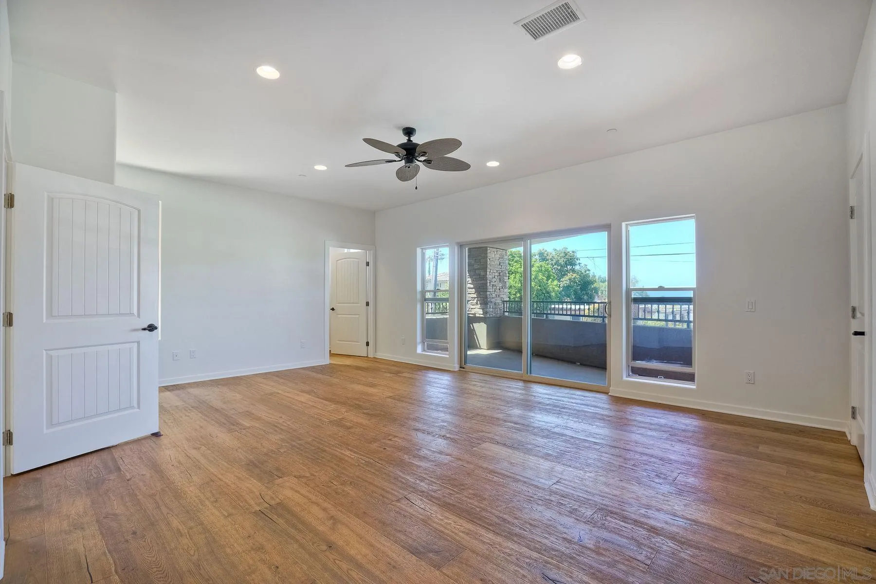 2009 MacKinnon Avenue Encinitas, CA 92007 - Photo 9 of 46 a view of an empty room with a window and wooden floor