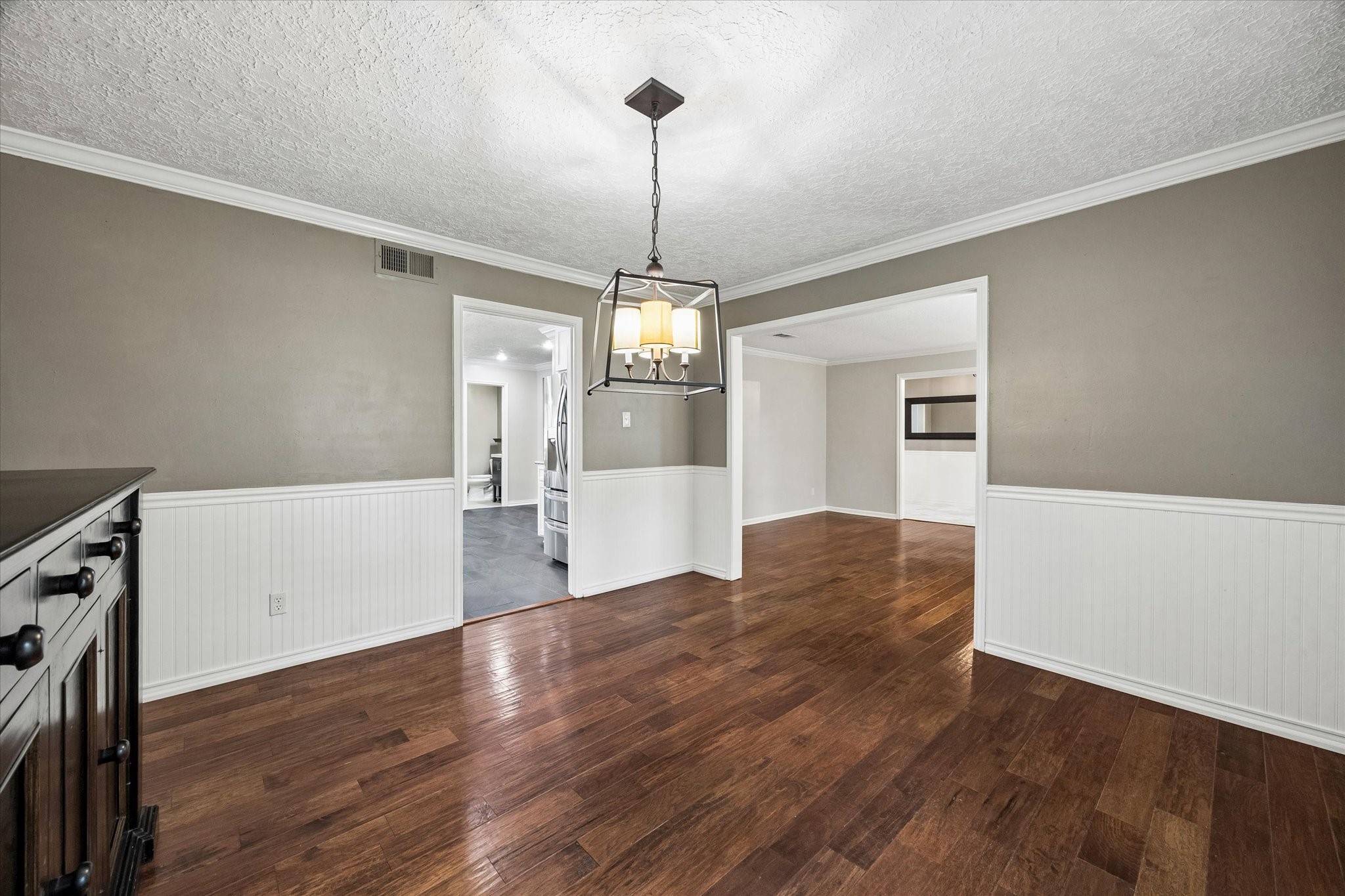 9410 Taidswood Drive Spring, TX 77379 - Photo 15 of 40 This is another angle from inside the formal dining room showing the entrance to the kitchen on the left and the opening to formal living room and entry way to the right.