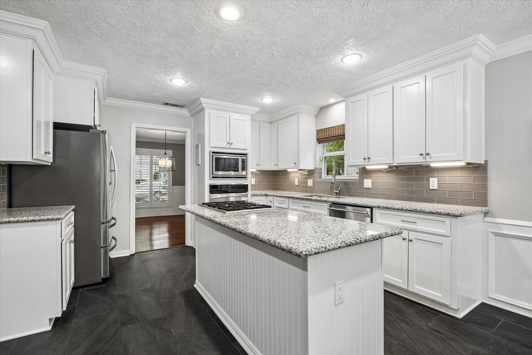 9410 Taidswood Drive Spring, TX 77379 - Photo 20 of 40 This angle of the kitchen shows the entrance to the formal dining room. You get to enjoy the formal dining on one side of the kitchen and the breakfast room on the other side! All appliances convey with the home.