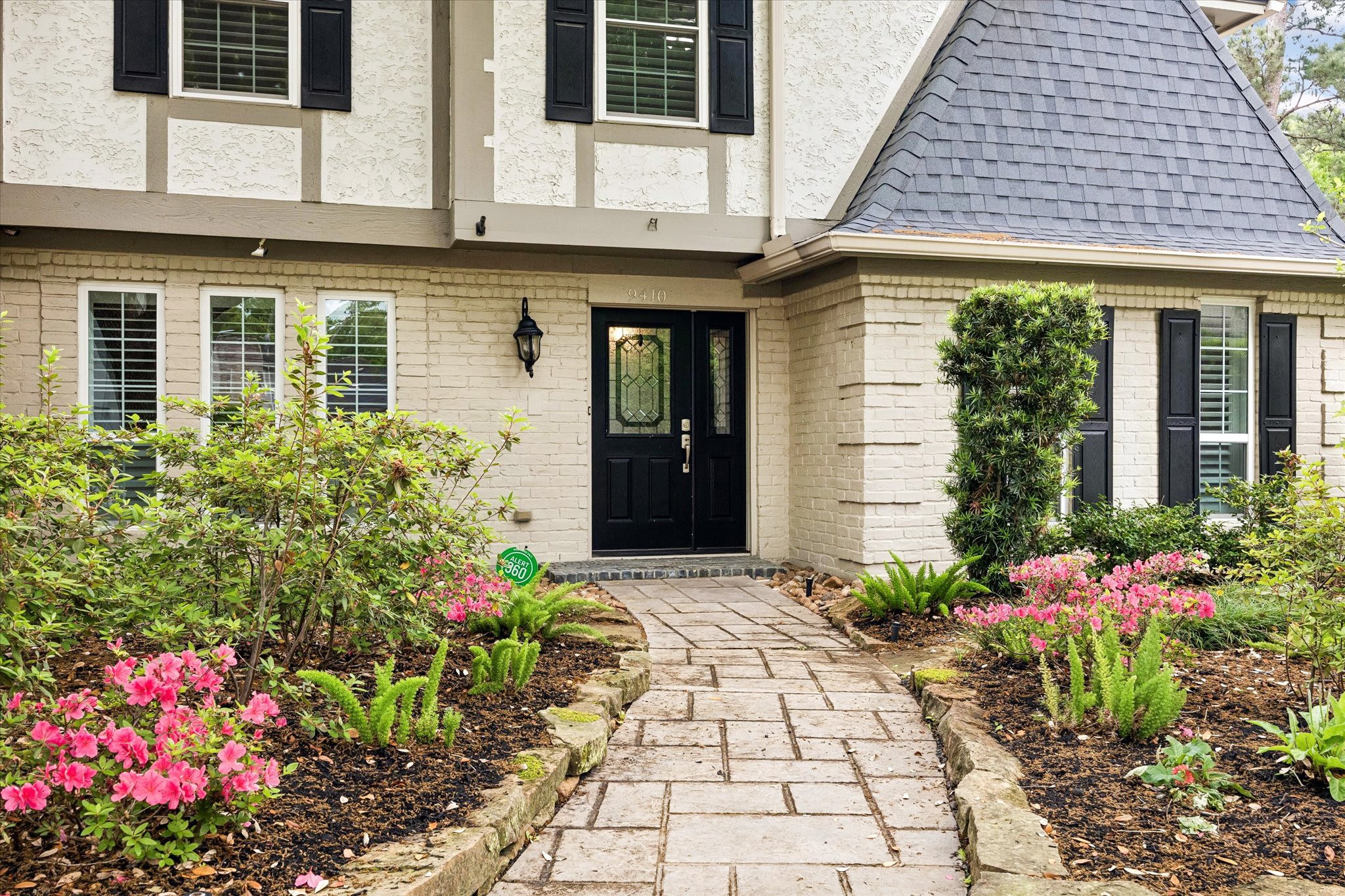 9410 Taidswood Drive Spring, TX 77379 - Photo 2 of 40 This French style tudor home is situated on a large lot with beautiful brick walk up and mature professionally installed landscaping to welcome to your guests!