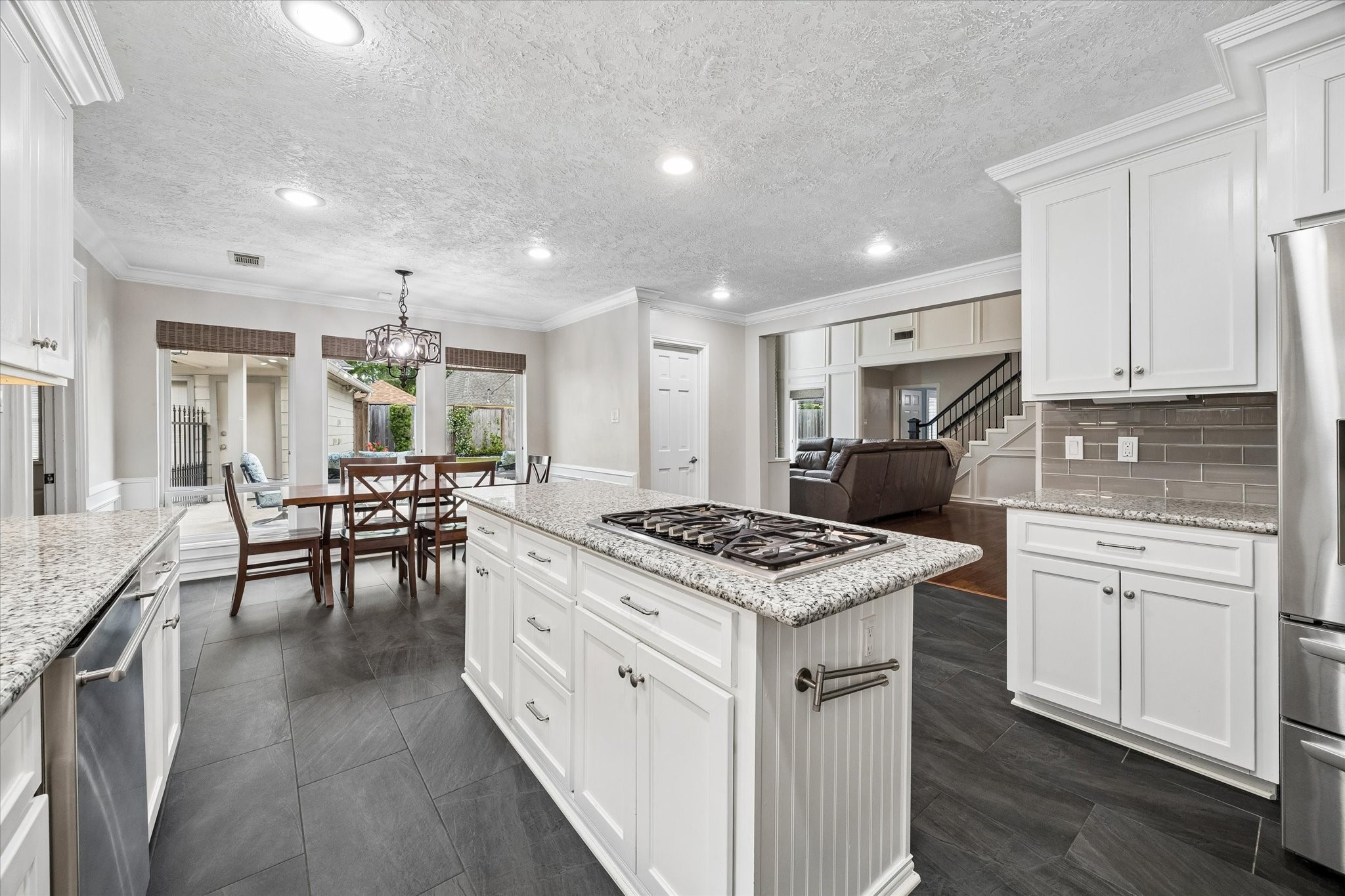 9410 Taidswood Drive Spring, TX 77379 - Photo 22 of 40 From this angle in the kitchen you can see the large breakfast area/eat-in kitchen, a view into the family room, the stairs, and out the many windows facing the beautiful backyard!