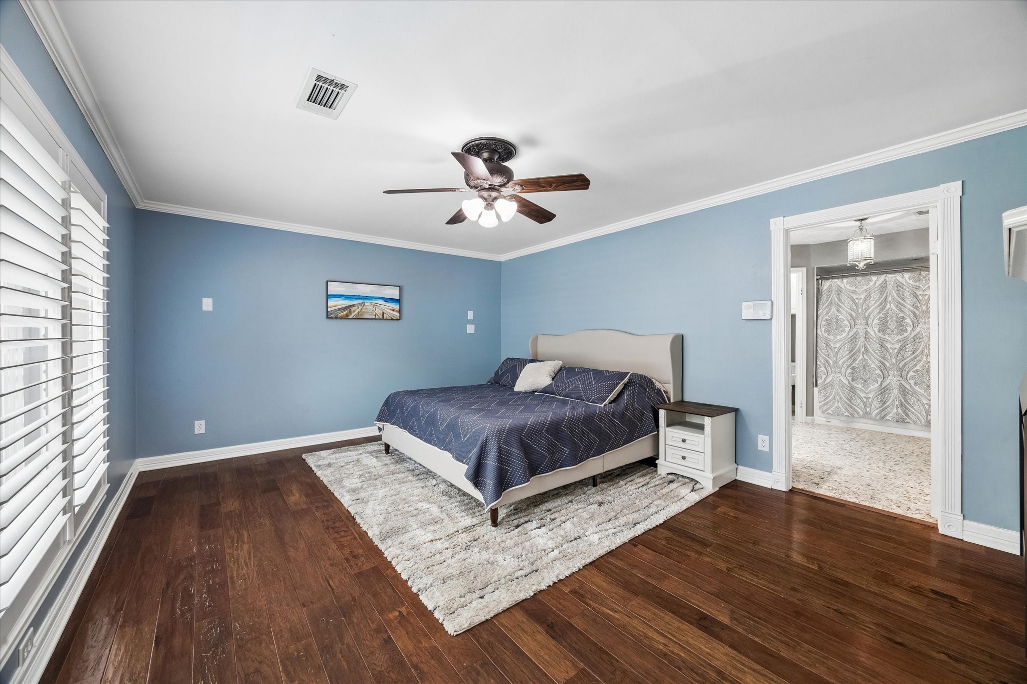 9410 Taidswood Drive Spring, TX 77379 - Photo 25 of 40 The primary bedroom is situated on the first floor and has recently been painted a calming blue, features a ceiling fan and faces the backyard pool!
