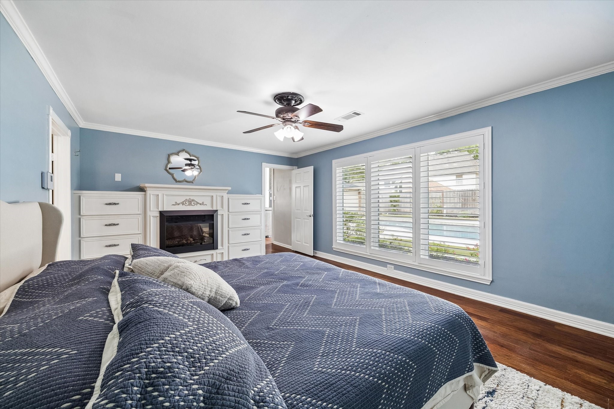 9410 Taidswood Drive Spring, TX 77379 - Photo 26 of 40 The primary suite also comes with a built in electric fireplace and additional cabinetry for storage. Beautiful views during the day of the pool and relaxing views of the fireplace by night!