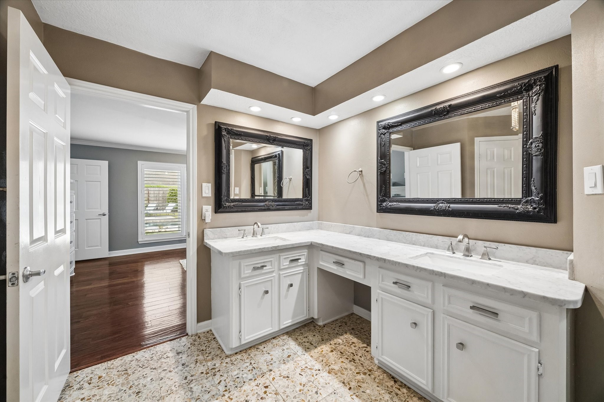 9410 Taidswood Drive Spring, TX 77379 - Photo 27 of 40 The primary bathroom features two sinks, separated by the long L shaped vanity, and two mirrors. It also features TWO separate walk-in closets!!!