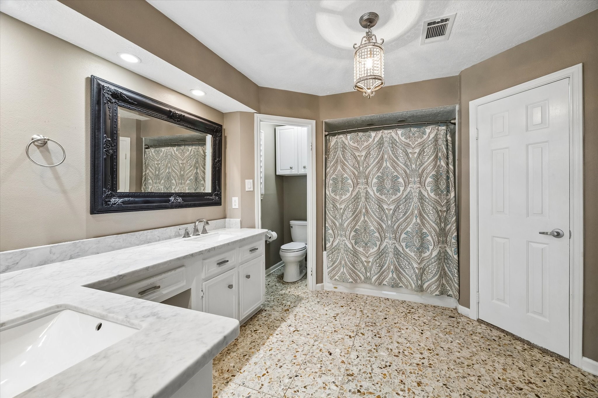 9410 Taidswood Drive Spring, TX 77379 - Photo 28 of 40 This angle of the primary bathroom suite shows the separate water closet for toilet, the shower and tub combo, and the first or TWO walk-in closets in this space!