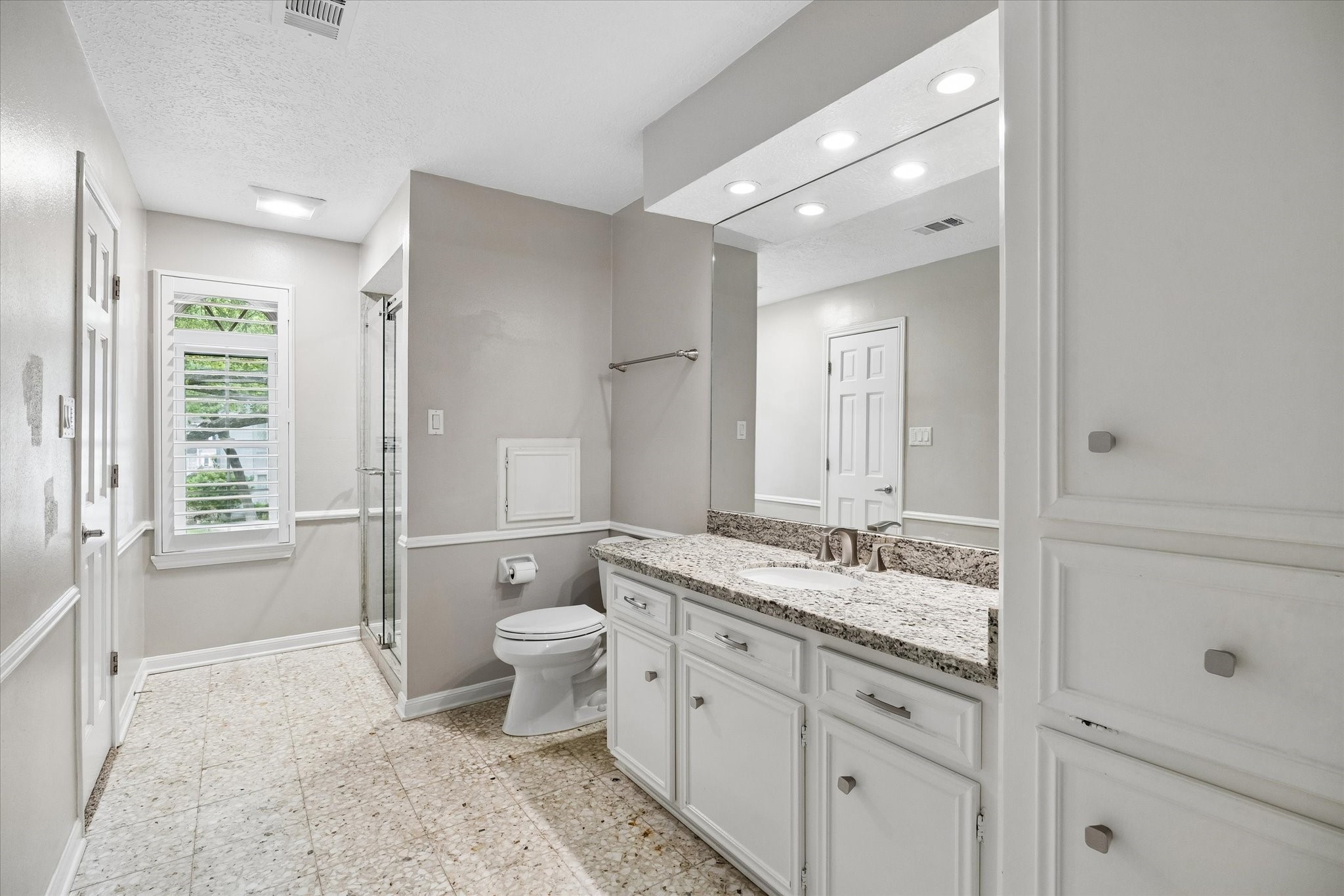 9410 Taidswood Drive Spring, TX 77379 - Photo 35 of 40 A view of the more private upstairs bathroom which features a stand up shower and loads of storage space! From this angle you can see the door to the bedroom, and standing behind the camera man is the access door to the game room.