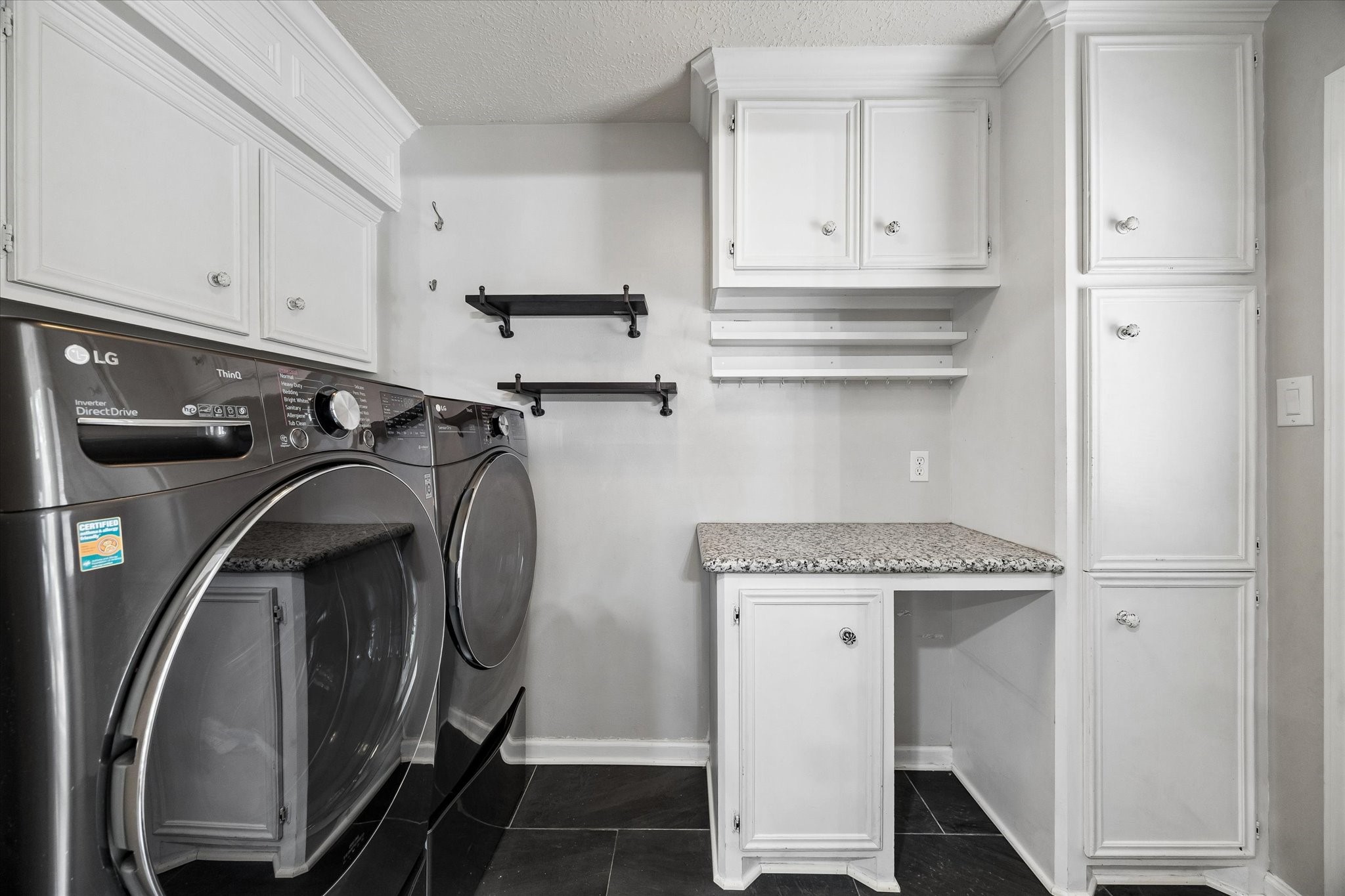 9410 Taidswood Drive Spring, TX 77379 - Photo 37 of 40 The laundry room and mud room offer luxury appliances that will convey with the home, and the washer actually has additional features outlined in the brochure we have available for you to download. This room allows entry to the home from the backyard and driveway space directly off the garage. You won't have to ever get wet if you park in the garage and walk under the covered walk way!