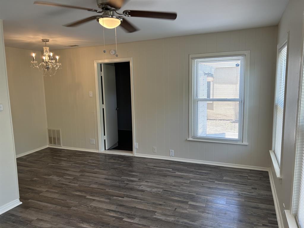 6318 Belgrade Avenue Dallas, TX 75227 - Photo 6 of 23 an empty room with wooden floor closet and windows