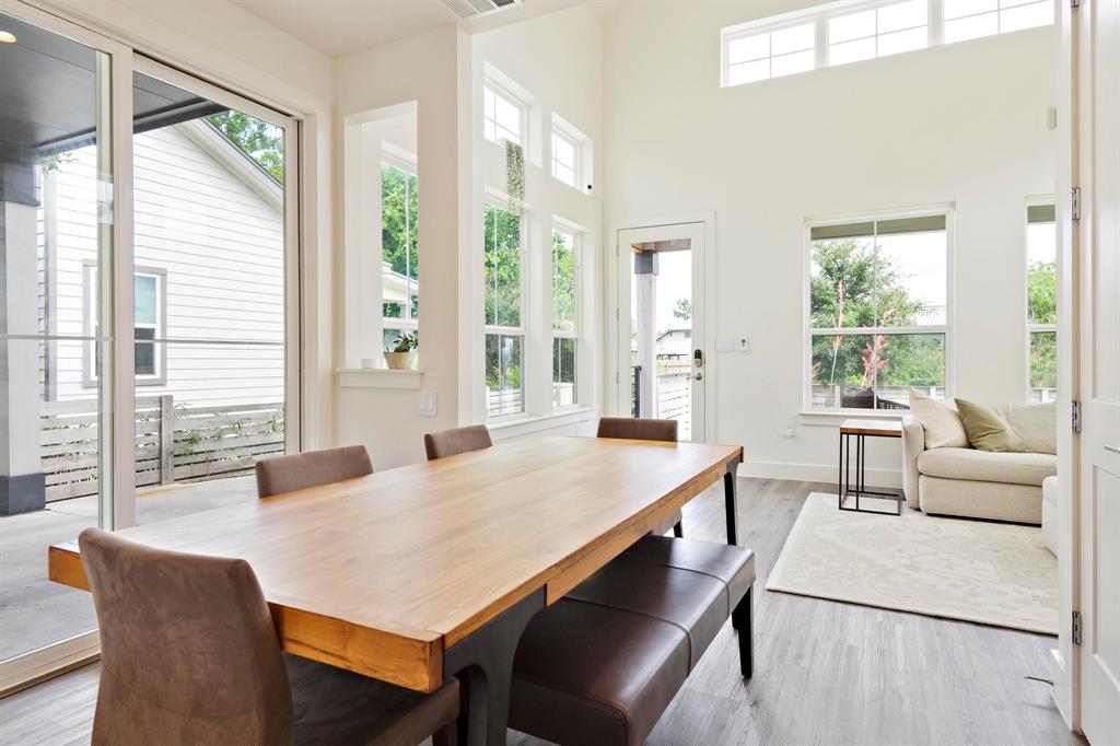 911 Stobaugh Street, Unit 2 Austin, TX 78757 - Photo 8 of 26 Spacious interior featuring high ceilings, light wood-finish flooring, and ample natural light from large windows and a glass sliding door