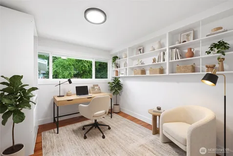 a workspace with furniture window and wooden floor