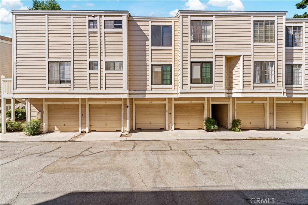 4900 North Grand Avenue, Unit 131 Covina, CA 91724 - Photo 12 of 12 a front view of a building with a road