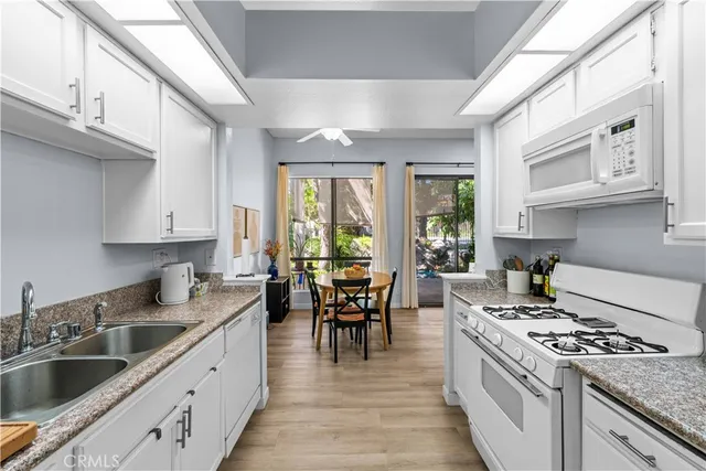 a kitchen with a stove top oven sink and cabinets