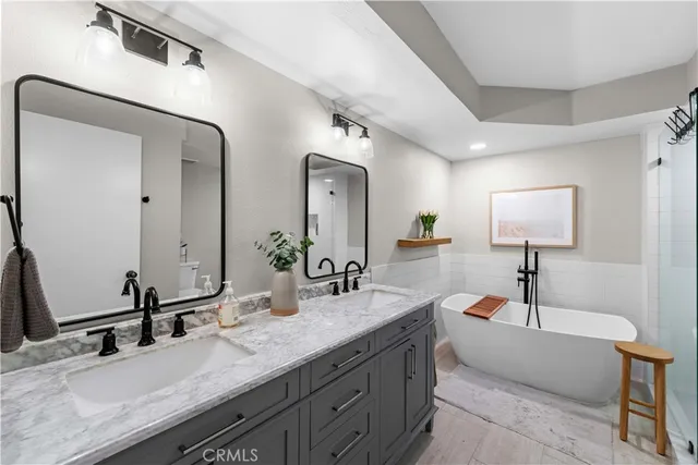 a bathroom with a double vanity sink and a mirror