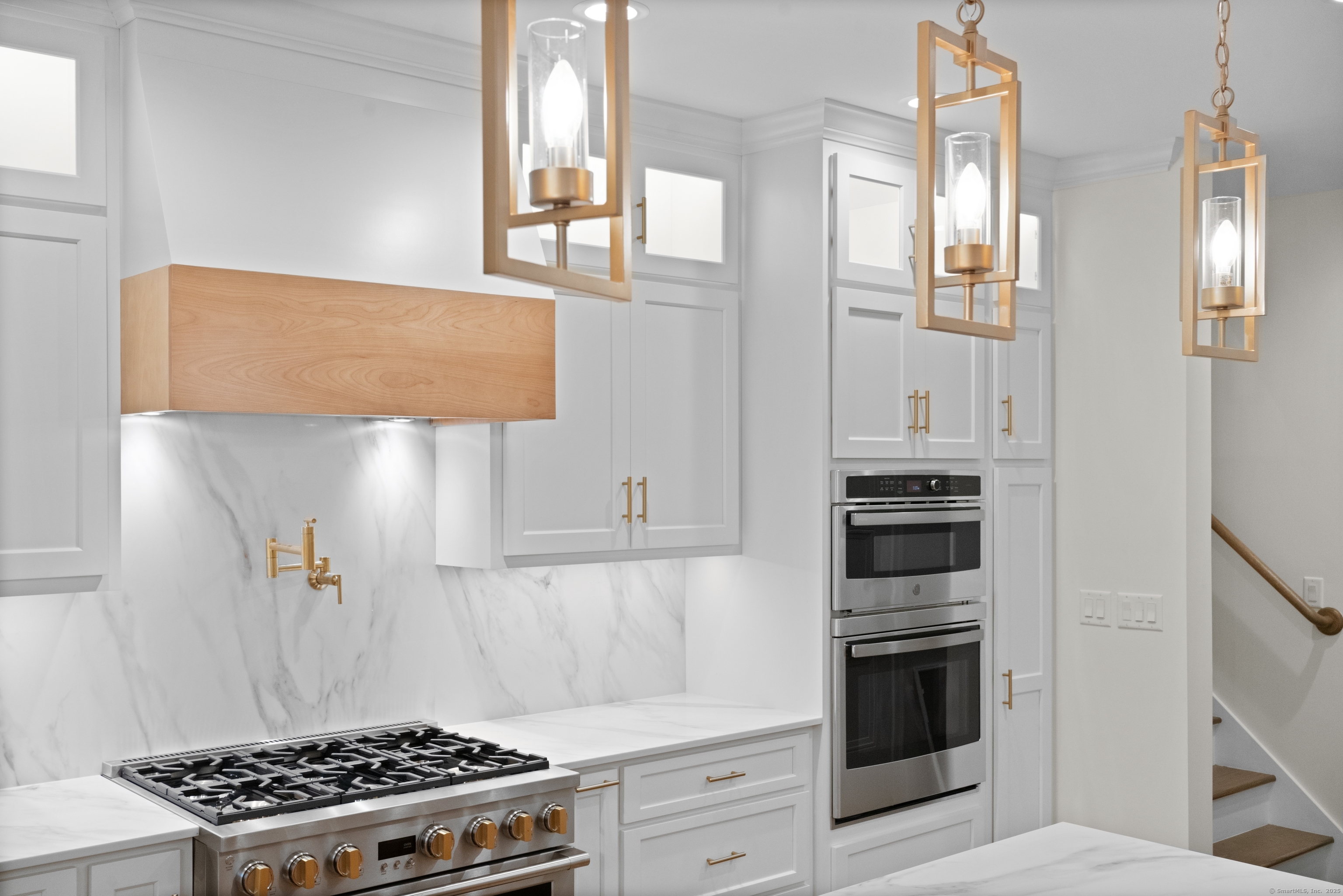 a kitchen with stainless steel appliances a stove a refrigerator and cabinets