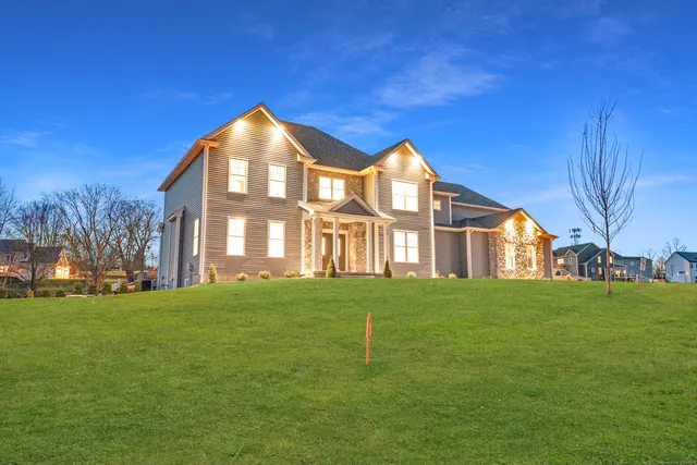a front view of a house with a yard