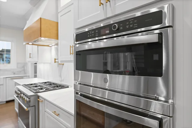 a stove top oven sitting inside of a kitchen